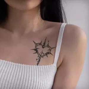 Edgy heart-shaped cross temporary tattoo with thorns